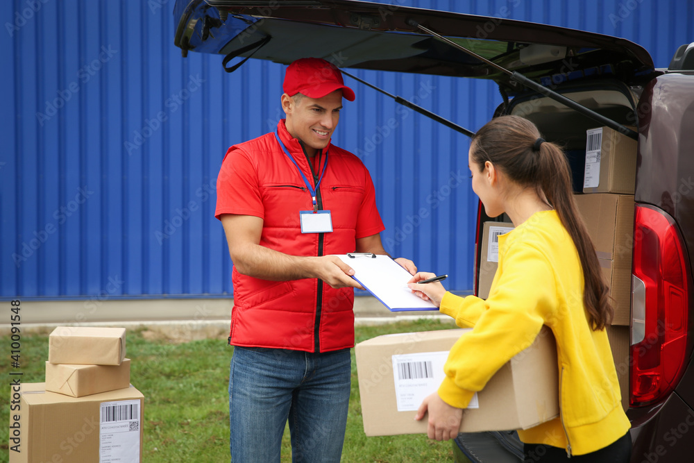 Courier receiving receipt signature from customer outdoors Courier receiving receipt signature from customer outdoors