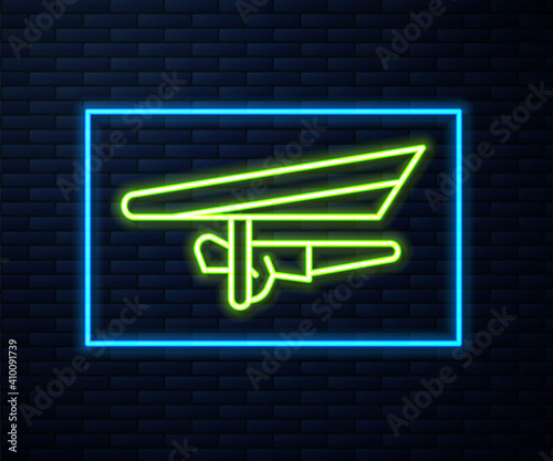 Glowing neon line Hang glider icon isolated on brick wall background. Extreme sport. Vector Illustration.