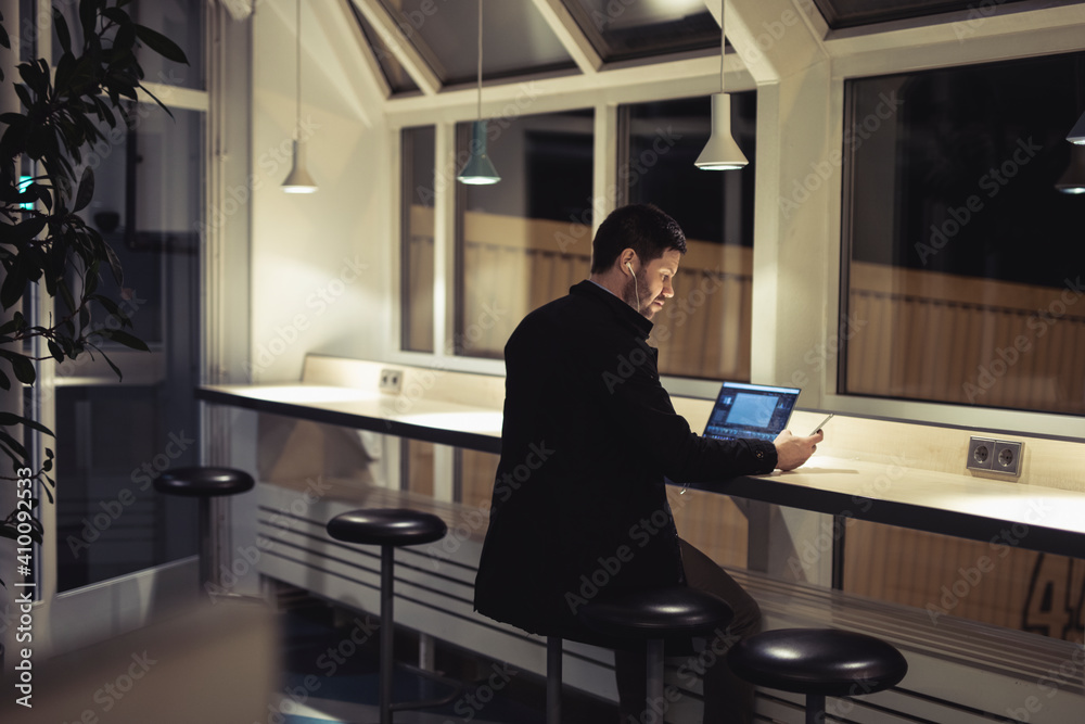 Man working with laptop in public space Man working with laptop in public space