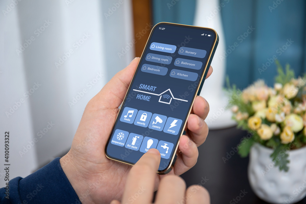 male hands holds phone with smart home application on screen male hands holds phone with smart home application on screen