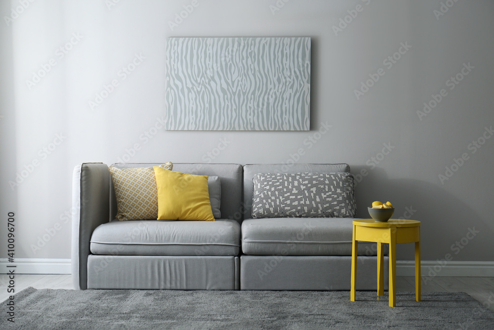 Stylish living room with sofa. Interior design in grey and yellow colors - obrazy, fototapety, plakaty 