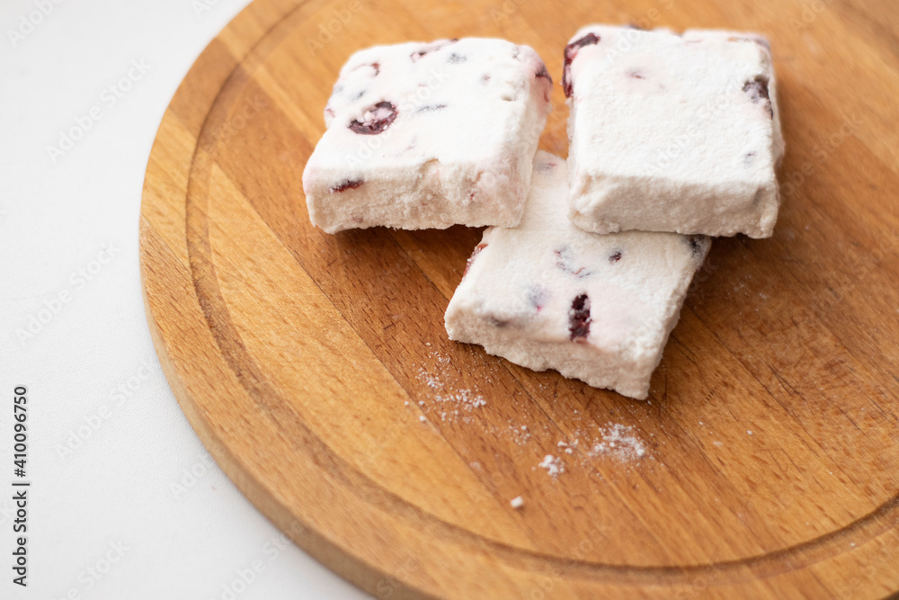 Sweets, marshmallows, lying on a wooden board, on the windowsill. Surprise, holiday of sweets, sugar addiction, handmade, the right sweets Sweets, marshmallows, lying on a wooden board, on the windowsill. Surprise, holiday of sweets, sugar addiction, handmade, the right sweets