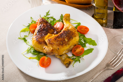 Roasted chicken thighs with arugula and tomatoes. Healthy dinner
