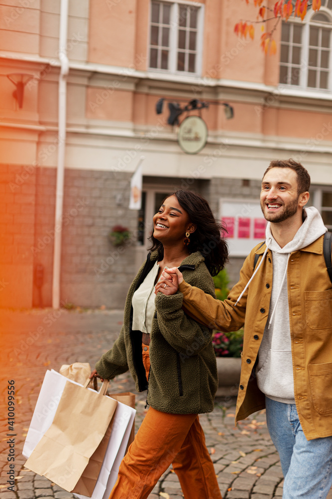 Young couple walking with shopping bags Young couple walking with shopping bags