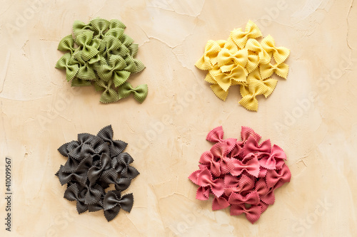 Heaps of pasta - various colors farfalle pasta, top view