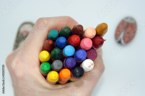 Colorful crayons for painting on a white background.
