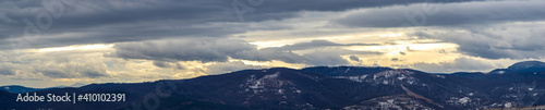 The Sun behind the clouds in winter in the mountains © onyx124