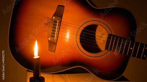 classic acoustic guitar close up in bright candlelight