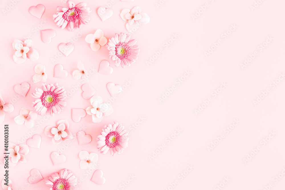 Valentine's Day background. Pink flowers, hearts on pastel pink background. Valentines day concept. Flat lay, top view, copy space Valentine's Day background. Pink flowers, hearts on pastel pink background. Valentines day concept. Flat lay, top view, copy space