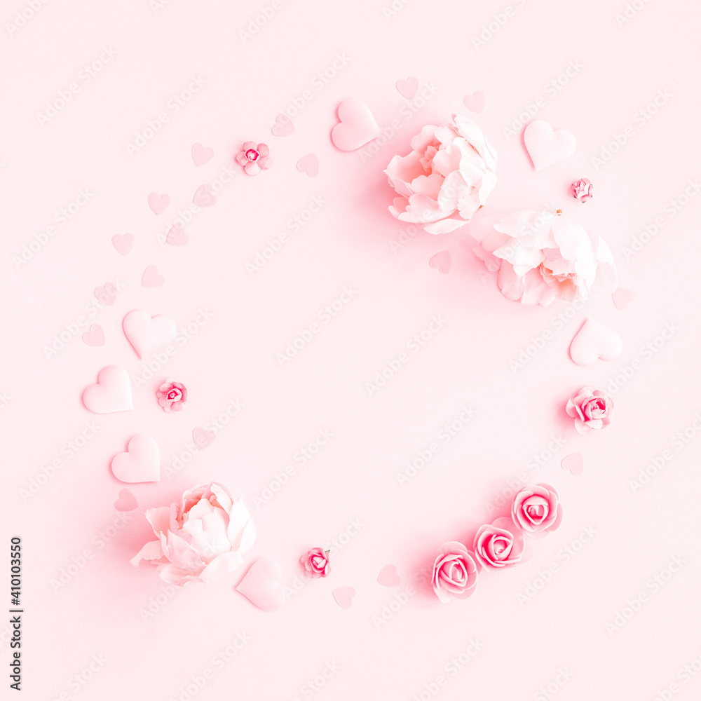 Valentine's Day background. Wreath made of pink flowers, hearts on pastel pink background. Valentines day concept. Flat lay, top view, copy space