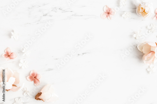 Flowers composition. White and pink flowers on marble background. Flat lay, top view