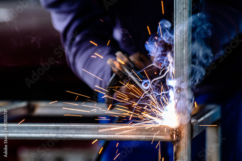Canvas Print welder and welding sparks, construction and metal work industrial concept, metal