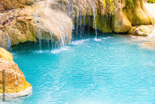 Fototapeta Naklejka Na Ścianę i Meble -  Tropical landscape with beautiful waterfall, emerald blue lake and rocks in wild jungle forest. Erawan National park, Thailand