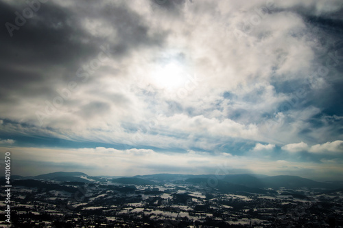 view of the snow-covered city with beautiful clouds and sky