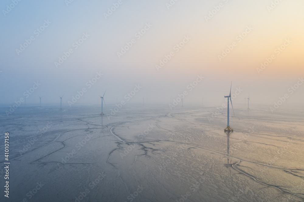 wind farm on tidal flat wetland in sunrise wind farm on tidal flat wetland in sunrise