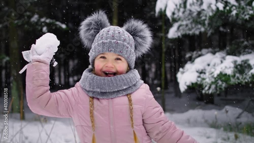 Handheld video of little girl throwing a snowball. Shot with RED helium camera in 8K.