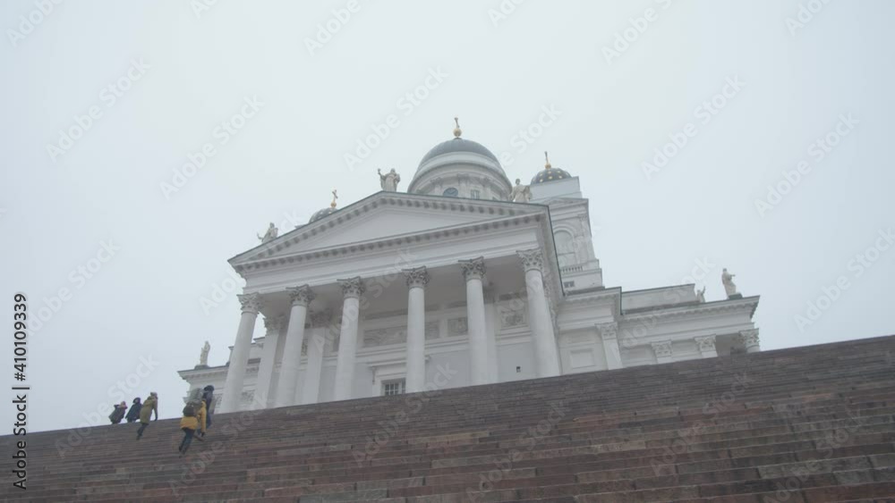 Tracking shot right to left of Helsinki Cathedral from low angle with steps leading up Tracking shot right to left of Helsinki Cathedral from low angle with steps leading up