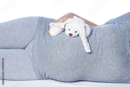 Happy pregnant girl lies on white background © Kostia