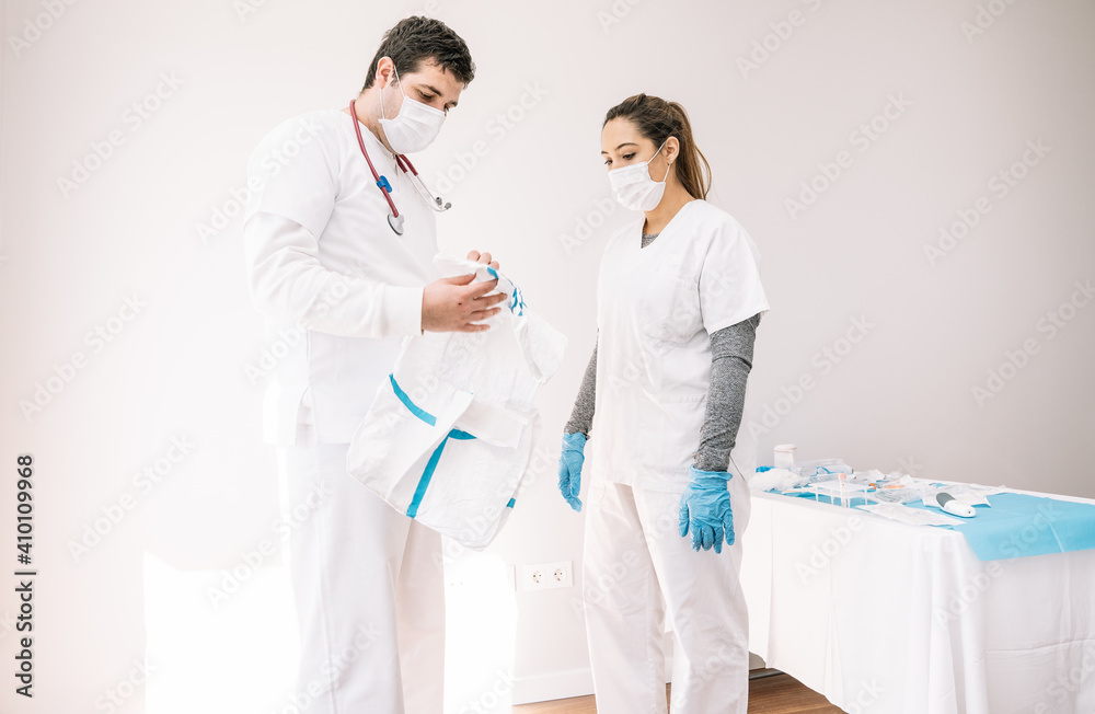 Doctors in masks standing with protective costume Doctors in masks standing with protective costume