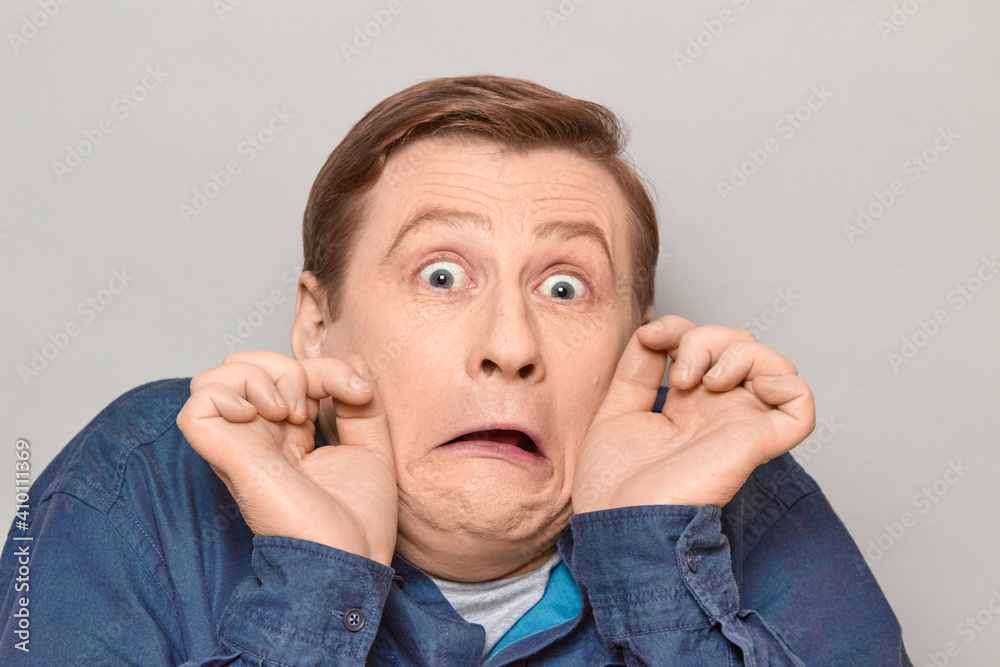 Portrait of shocked fearful mature man grimacing in horror Portrait of shocked fearful mature man grimacing in horror