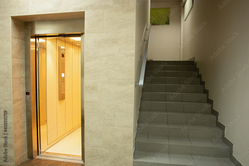 Fototapeta premium Elevator and stairs. Bright room