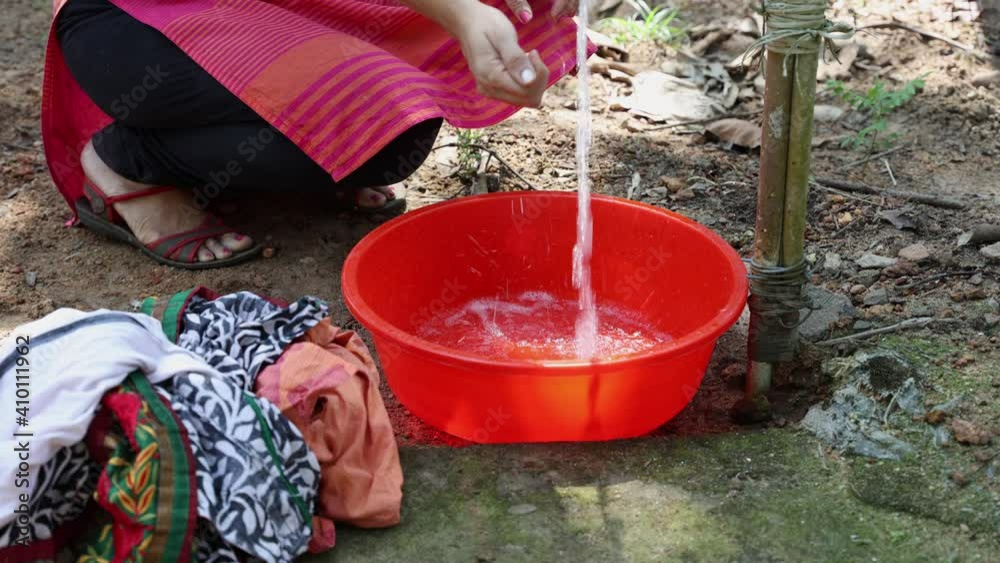 women-s-hands-putting-detergent-in-water-to-wash-dirty-clothes-in-basin