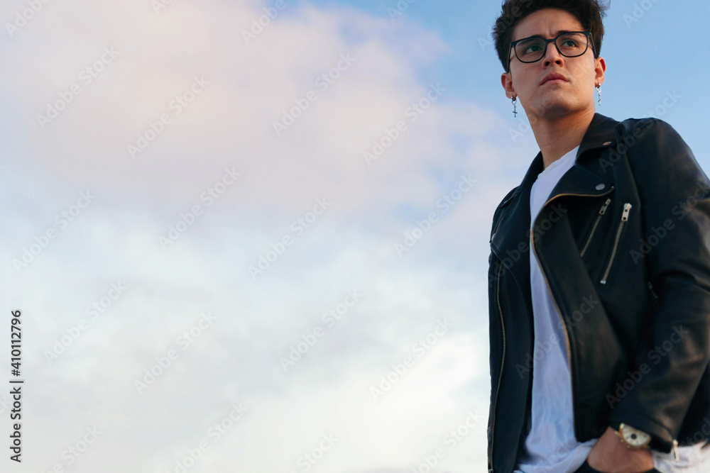 Serious young man looking away as he stands in the city. Serious young man looking away as he stands in the city.