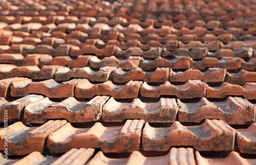 Old red ceramic tiles roof background. Abstract geometric pattern, Roof brick material.