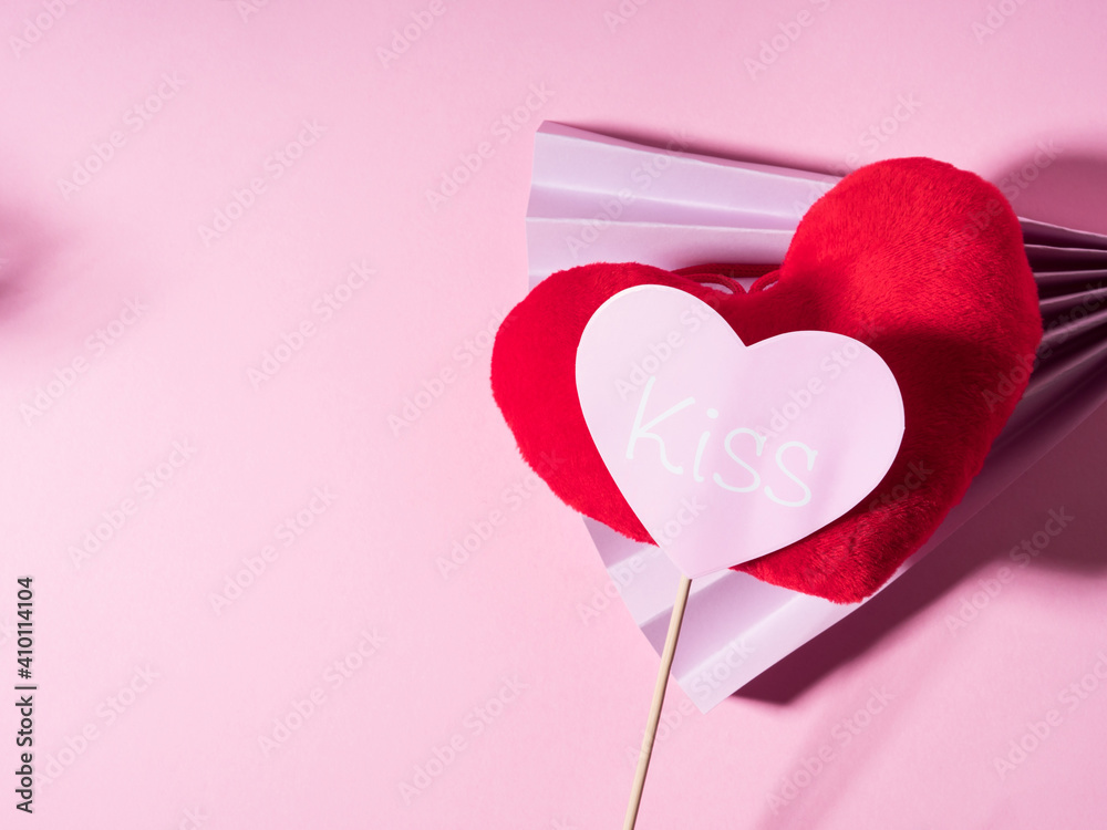 Trendy Valentines day backgound with stuffed red heart and purple paper fan on pink. Love concept with photo booth prop