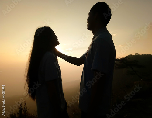 silhouette of a couple kissing on sunset