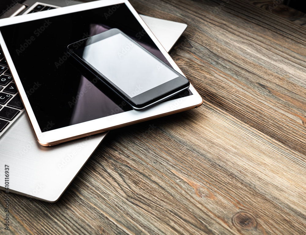 laptop with phone and tablet pc on wooden desk laptop with phone and tablet pc on wooden desk