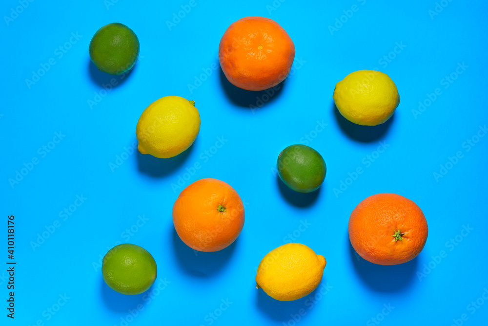 Whole oranges, limes and lemons with skin on blue background. CITRUS CITRIC Whole oranges, limes and lemons with skin on blue background. CITRUS CITRIC