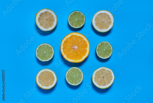 Orange, lime and lemon slices on a blue background. CITRUS CITRIC