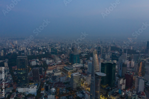 Saigon or Ho Chi Minh City Skyline, Vietnam aerial view at misty Golden hour with landmark buildings and urban sprawl