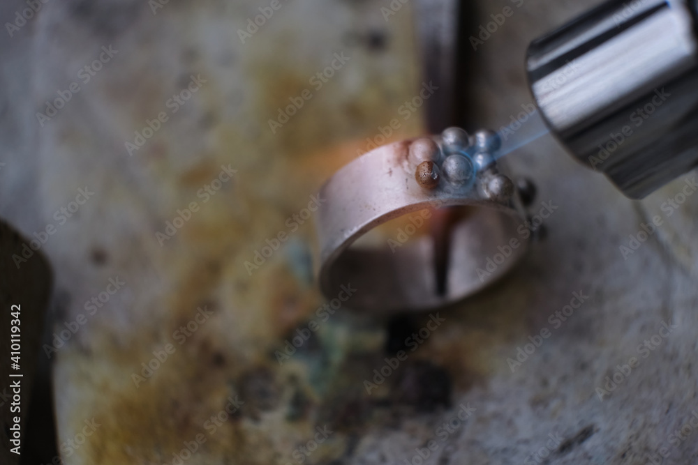 Macro shot. Craft jewelery making with professional tools. A handmade jeweler process, manufacture of jewellery. Melting metal Macro shot. Craft jewelery making with professional tools. A handmade jeweler process, manufacture of jewellery. Melting metal