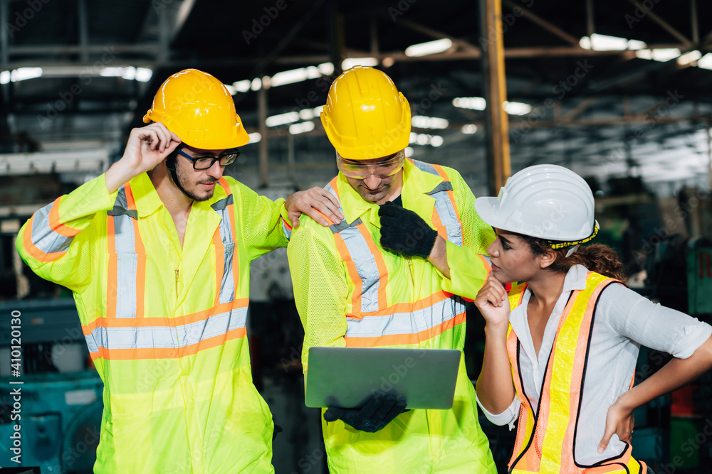 Work at factory.engineer woman and workers man team working together in safety work wear with white and yellow helmet using laptop computer.in factory workshop industry meeting professional Work at factory.engineer woman and workers man team working together in safety work wear with white and yellow helmet using laptop computer.in factory workshop industry meeting professional