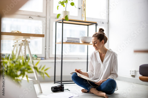 Young female freelancer working in loft office
