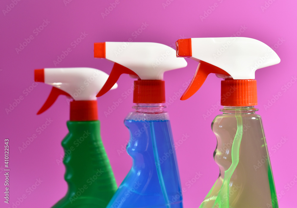 Detergent spray cleaner on purple background. Detergents for washing windows and cleaning dishes. Concentrated and anti-bacterial liquids for remove carbon, grease and dirt Detergent spray cleaner on purple background. Detergents for washing windows and cleaning dishes. Concentrated and anti-bacterial liquids for remove carbon, grease and dirt