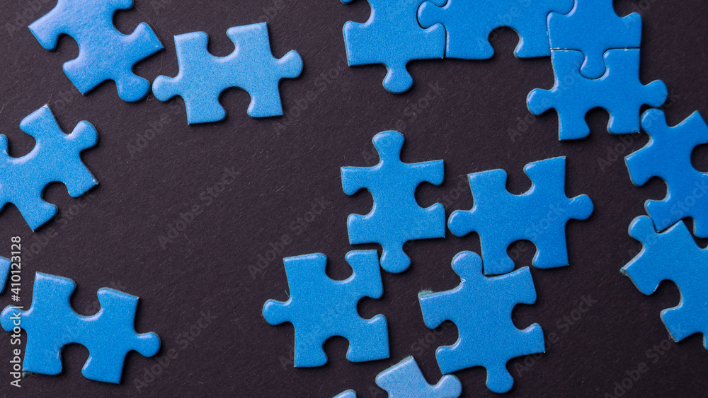 blue puzzle pieces on colored background