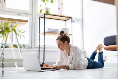 Creative young woman working on laptop in her studio 