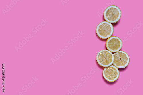 Lemon slices on a pink background. CITRUS CITRIC