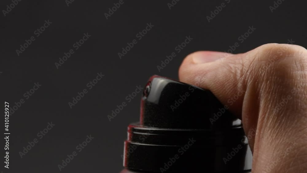 close shot of hand holding a spray bottle close shot of hand holding a spray bottle