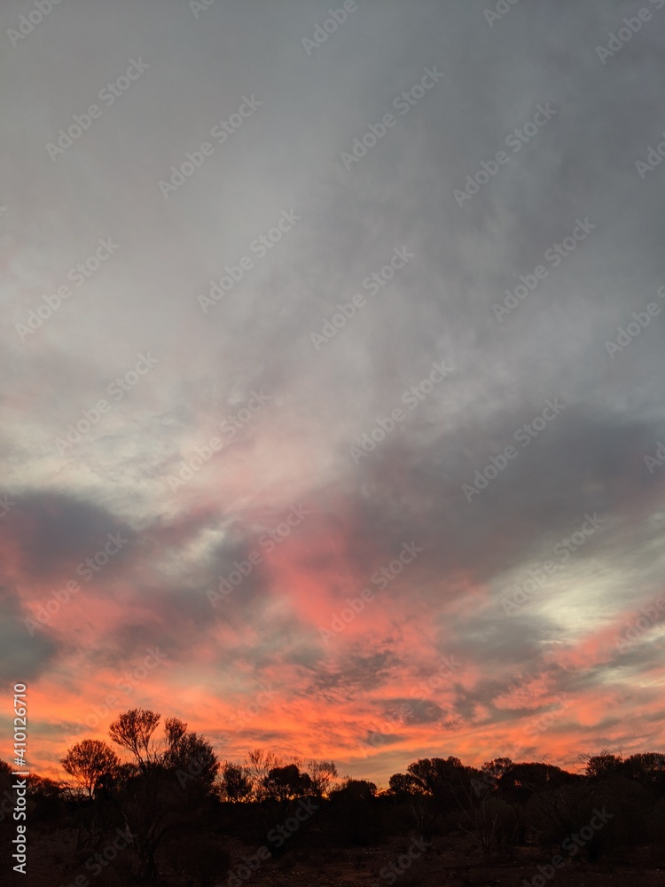 Red and grey clouds moving across the sky after the sun has set. Red and grey clouds moving across the sky after the sun has set.