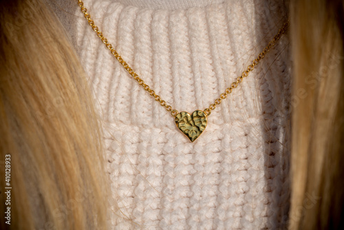 Close up Golden heart Necklace on neck with blond hair