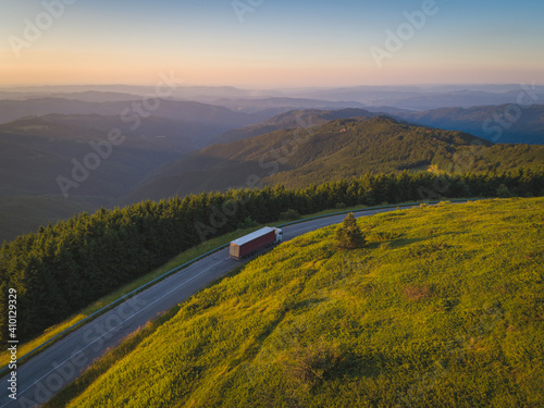 Canvas Print Truck with delivery driving the mountains at sunset
