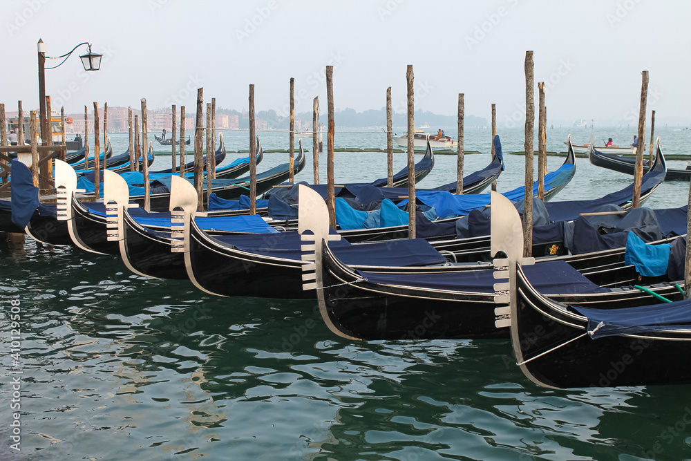Venice, Italy - Winter 2020: empty gondolas stopped at the city center dock