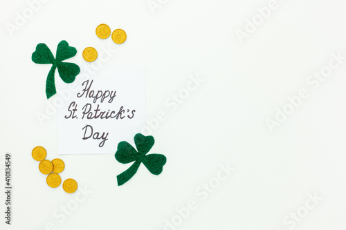 Composition for St. Patrick's Day. Decorating paper with green clover or shamrocks, gold coins and horseshoe.