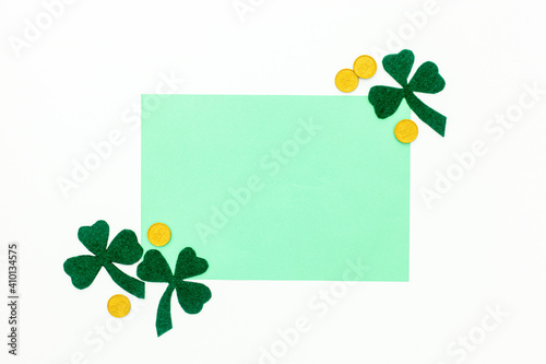 Composition for St. Patrick's Day. Decorating paper with green clover or shamrocks, gold coins and horseshoe.