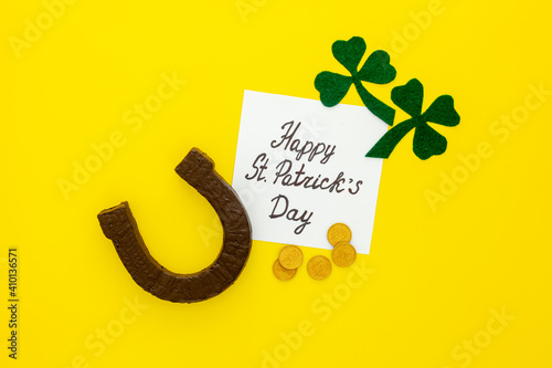 Composition for St. Patrick's Day. Decorating paper with green clover or shamrocks, gold coins and horseshoe