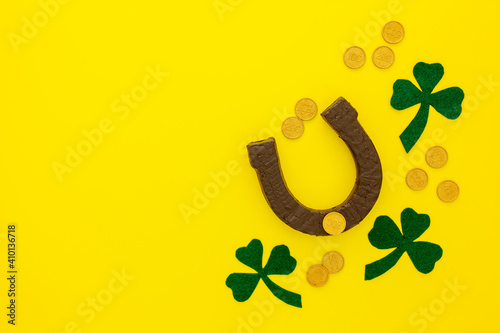 Composition for St. Patrick's Day. Decorating paper with green clover or shamrocks, gold coins and horseshoe